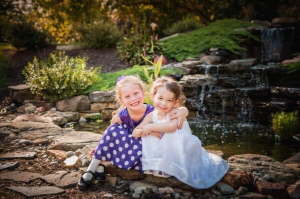 two girls having their picture taken