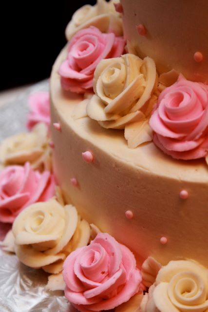 a cake with pink and white frosting flowers