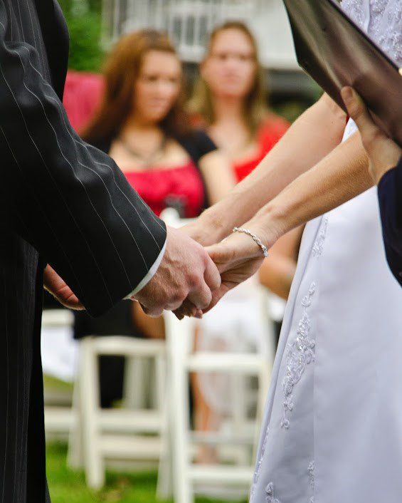 groom and bride holding hands